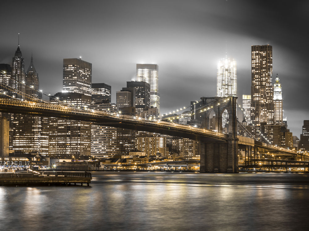 Evening shot of Brooklyn Bridge with Lower Manhattan skyline, New York