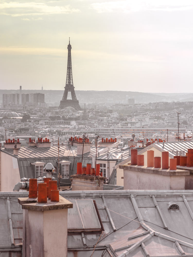 Eiffel Tower seen through the window of an apartment in Montmartre, Paris, France